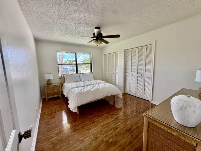 a bedroom with bed and wooden floor