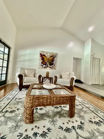 a living room with furniture and wooden floor