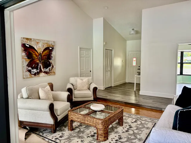 a living room with furniture and large windows