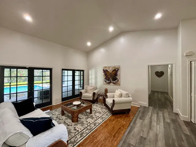 a kitchen with stainless steel appliances kitchen island granite countertop a sink and white cabinets