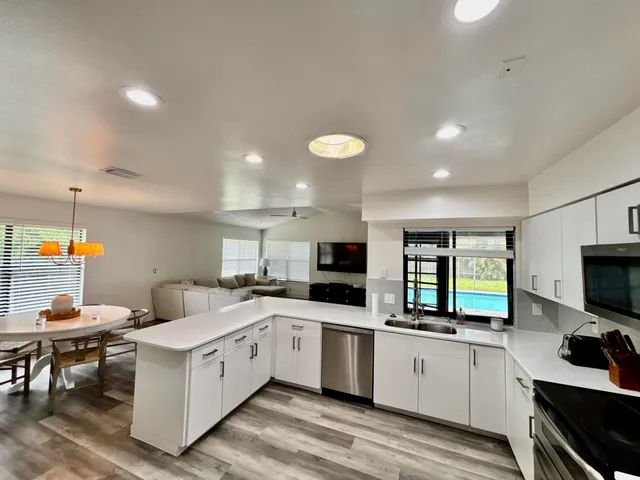 a kitchen with a refrigerator stove and microwave