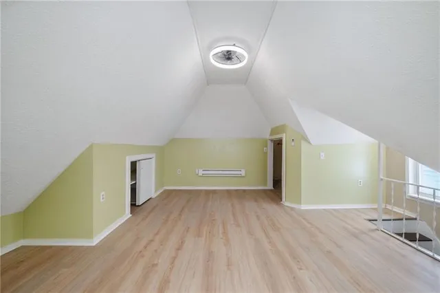 a view of a room with wooden floor