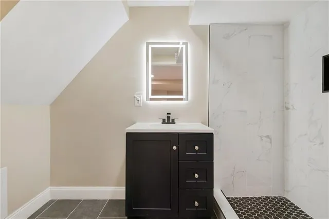a bathroom with a sink and a mirror