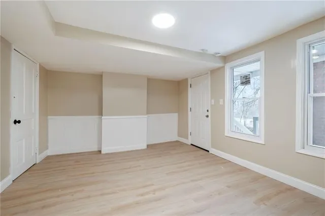 an empty room with windows and closet
