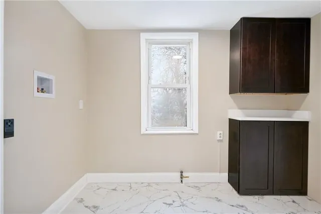 a view of a livingroom with wooden floor and a fireplace