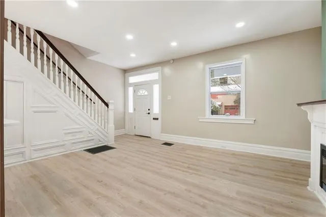 a view of an entryway with wooden floor