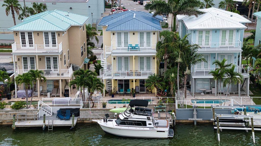 a front view of house and yard with swimming pool and furniture