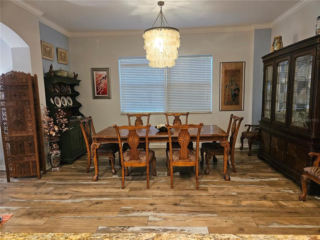 668 American Legion Drive Madeira Beach, FL 33708 - Photo 12 of 49 a view of a dining room with furniture window and wooden floor