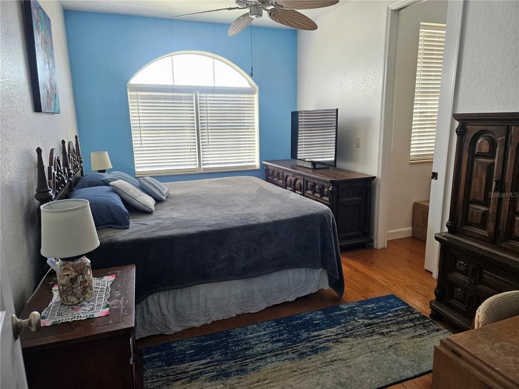 668 American Legion Drive Madeira Beach, FL 33708 - Photo 24 of 49 a bedroom with a bed and wooden floor