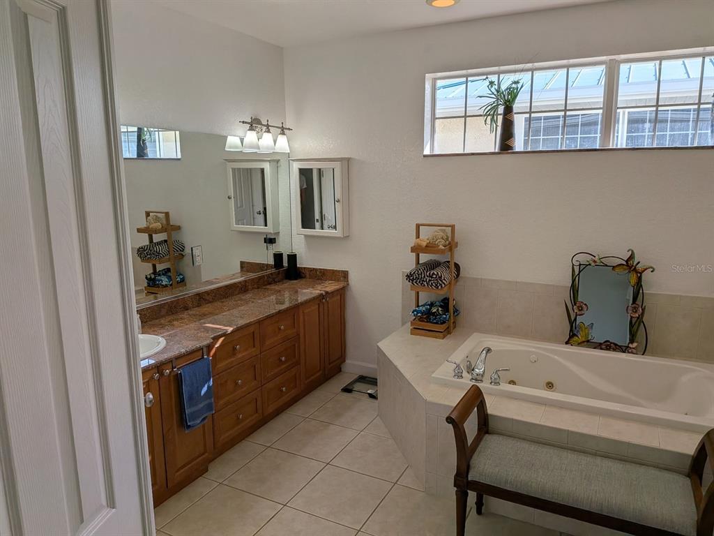 668 American Legion Drive Madeira Beach, FL 33708 - Photo 29 of 49 a bathroom with a sink and a mirror