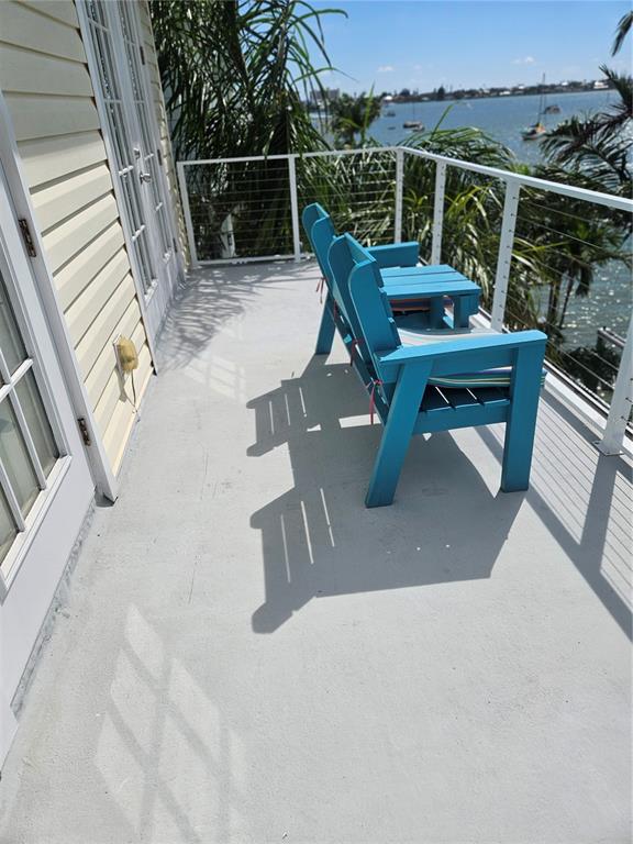 668 American Legion Drive Madeira Beach, FL 33708 - Photo 34 of 49 a roof deck with chairs and wooden fence
