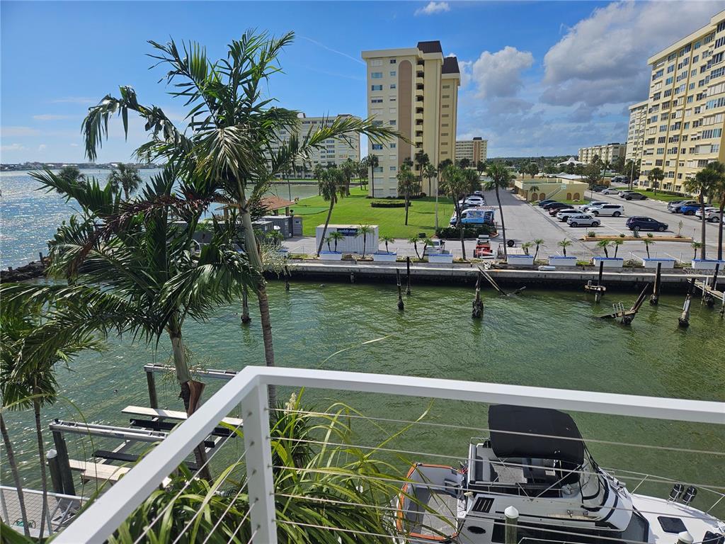 668 American Legion Drive Madeira Beach, FL 33708 - Photo 36 of 49 a view of a lake with a building in the background