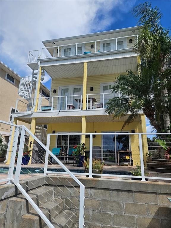 668 American Legion Drive Madeira Beach, FL 33708 - Photo 43 of 49 front view of a building with a fountain