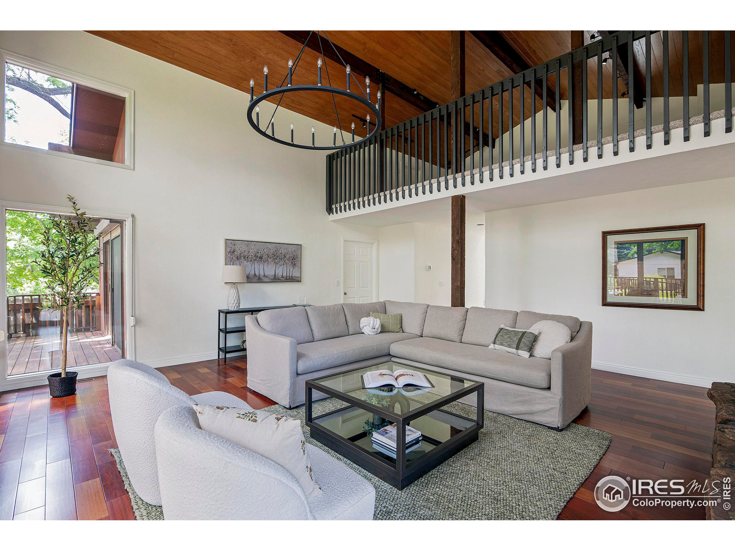7700 O Connor Road Boulder, CO 80303 - Photo 11 of 40 a living room with furniture a chandelier and a wooden floor