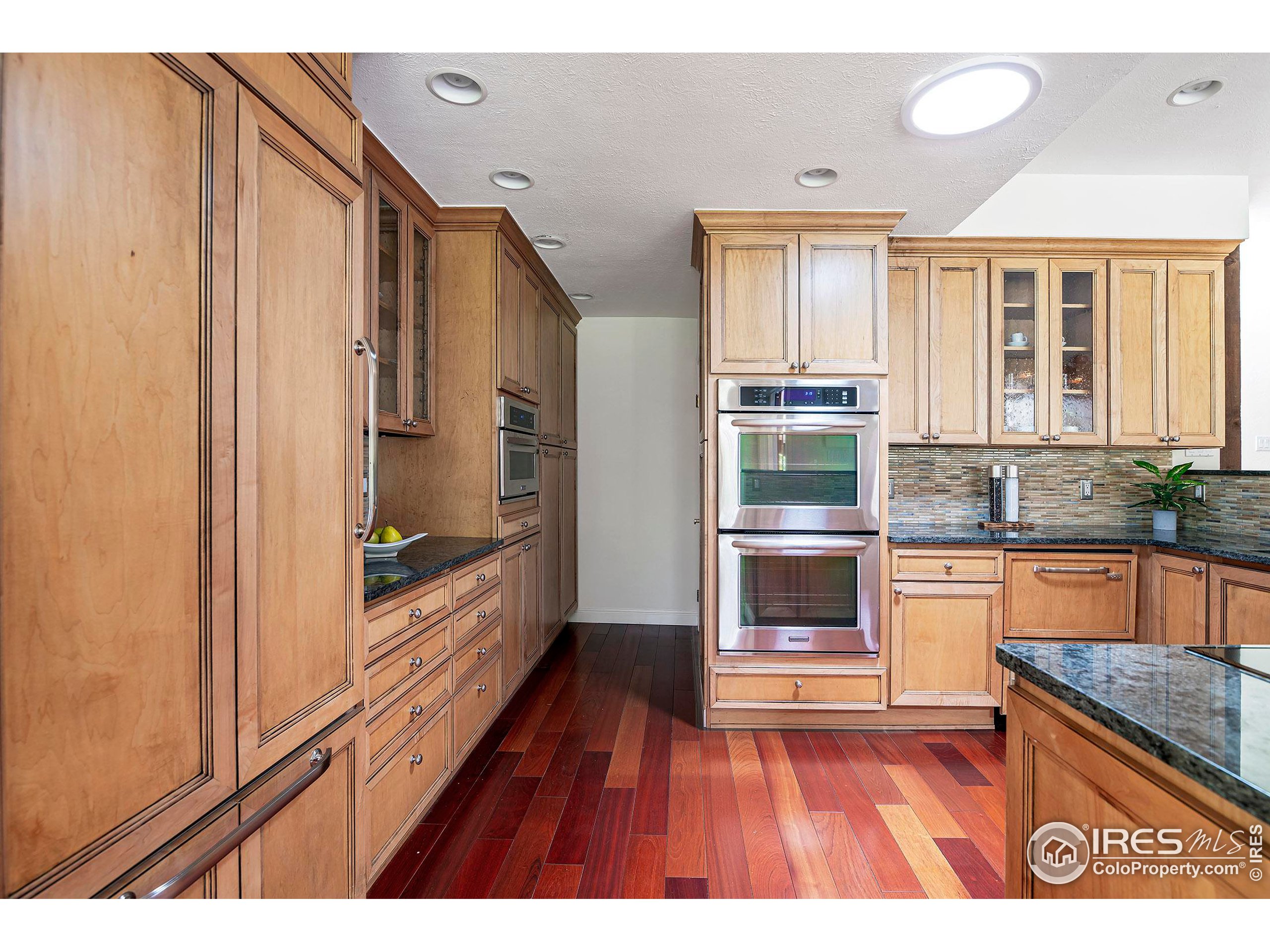 7700 O Connor Road Boulder, CO 80303 - Photo 16 of 40 a kitchen with granite countertop a refrigerator and a stove