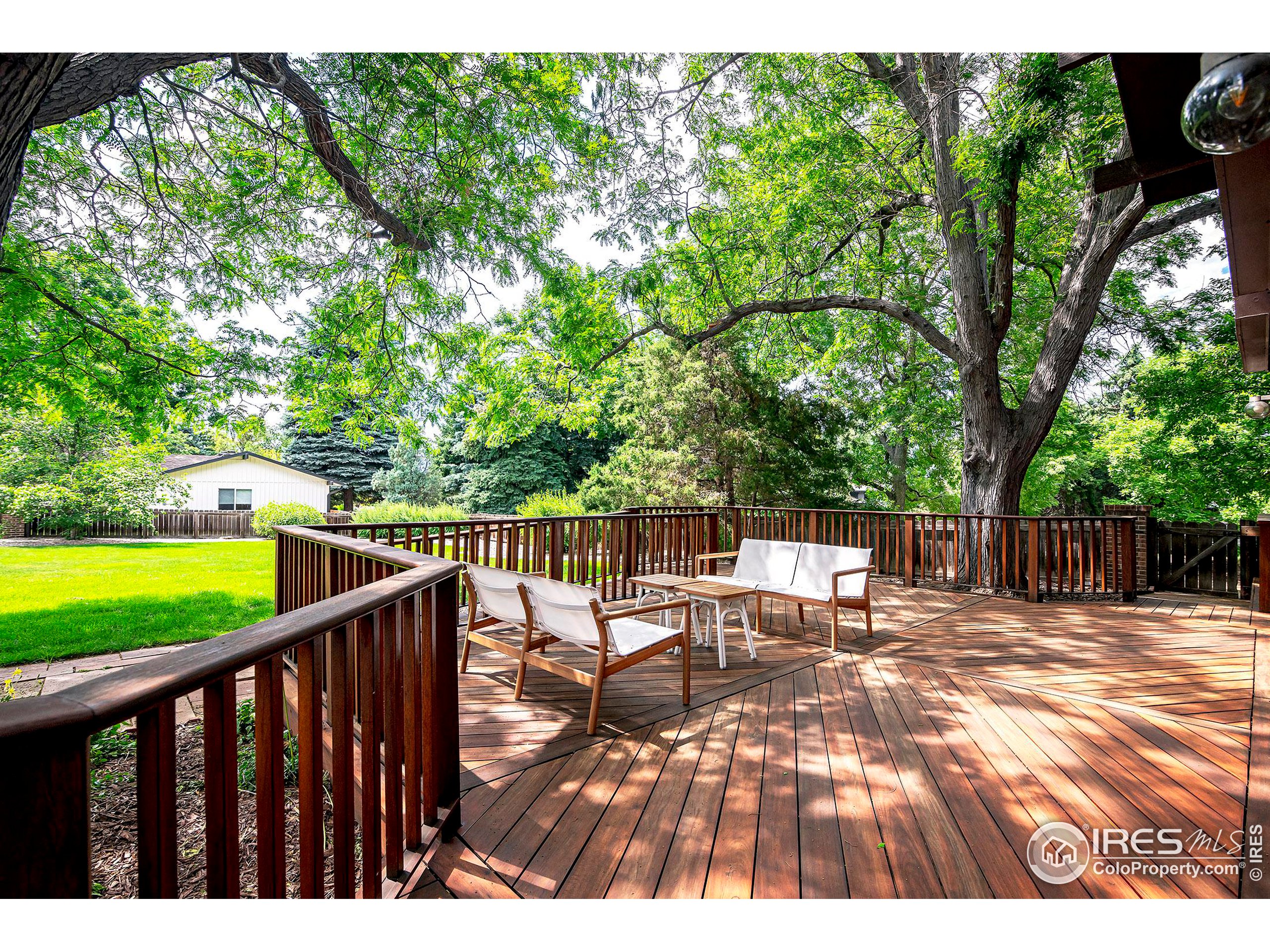 7700 O Connor Road Boulder, CO 80303 - Photo 34 of 40 a view of swimming pool with lawn chairs and wooden fence