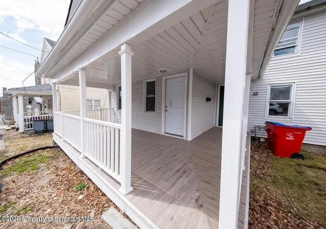 a view of a room with wooden floor and wooden fence