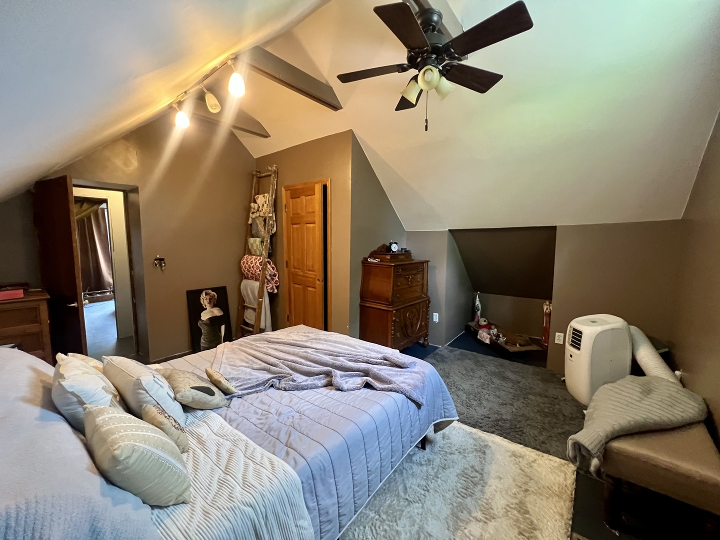 207 2nd Street Broadlands, IL 61816 - Photo 27 of 45 a bedroom with a bed and a chandelier