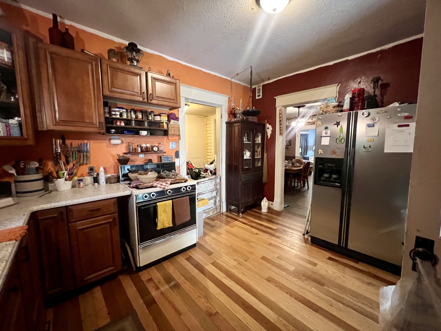 207 2nd Street Broadlands, IL 61816 - Photo 10 of 45 a kitchen with stainless steel appliances granite countertop a refrigerator a stove and a sink with wooden floors
