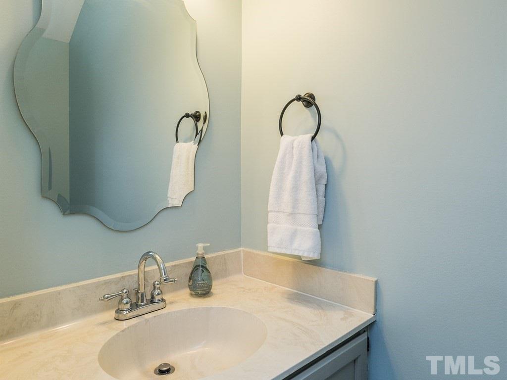 5306 Ridgeloch Place Raleigh, NC 27612 - Photo 14 of 23 a bathroom with a sink and a mirror