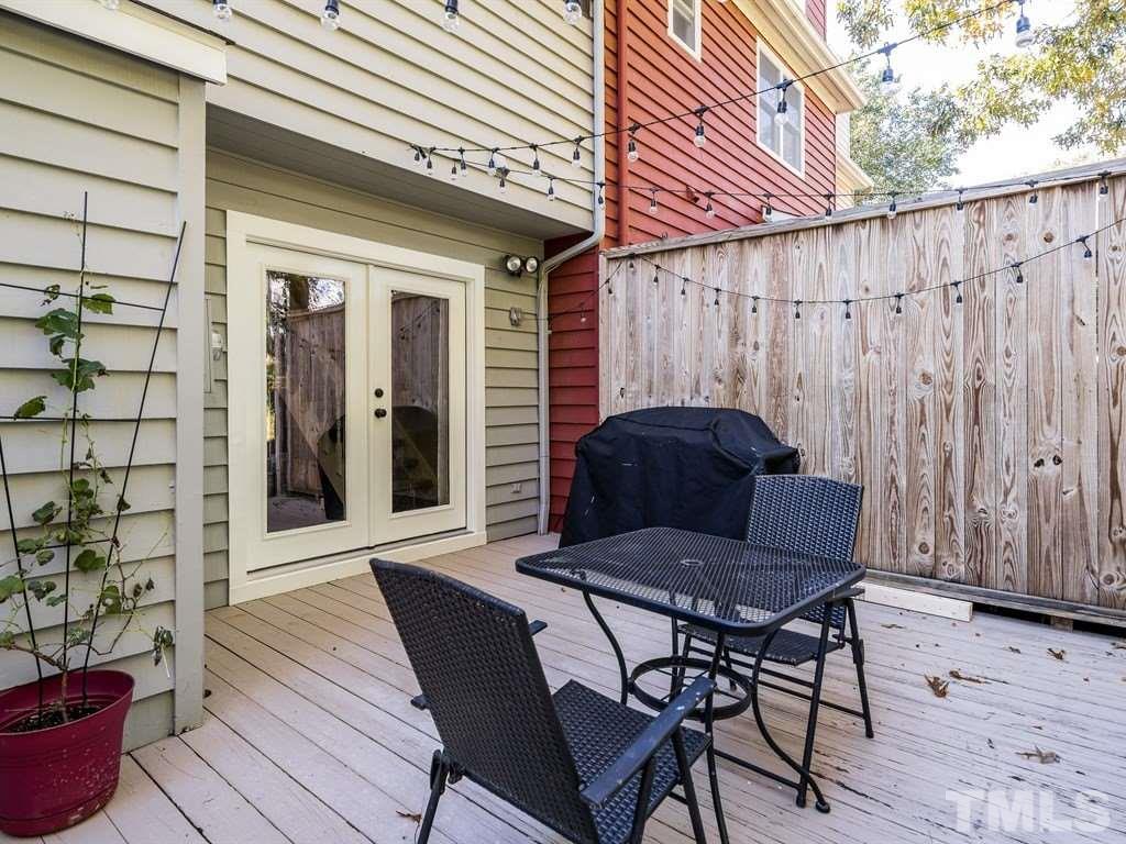 5306 Ridgeloch Place Raleigh, NC 27612 - Photo 22 of 23 a view of a patio with table and chairs and wooden floor
