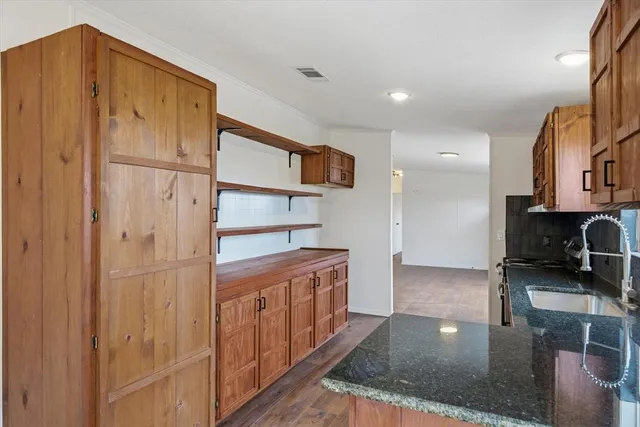 a kitchen with stainless steel appliances granite countertop a refrigerator and a sink