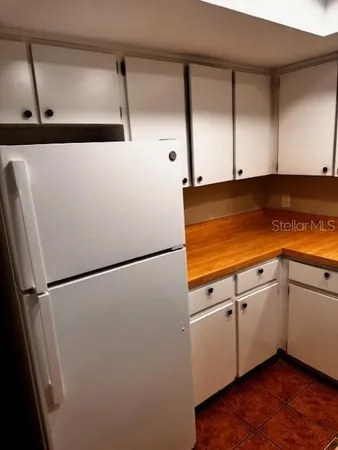 a white refrigerator freezer sitting inside of a kitchen