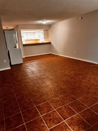 a view of a room with an empty space and a window