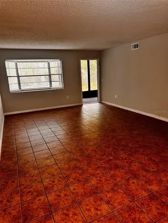a view of a livingroom with wooden floor and windows