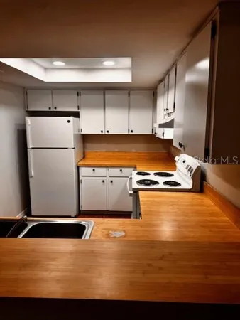 a kitchen with stainless steel appliances granite countertop a sink counter space and a refrigerator