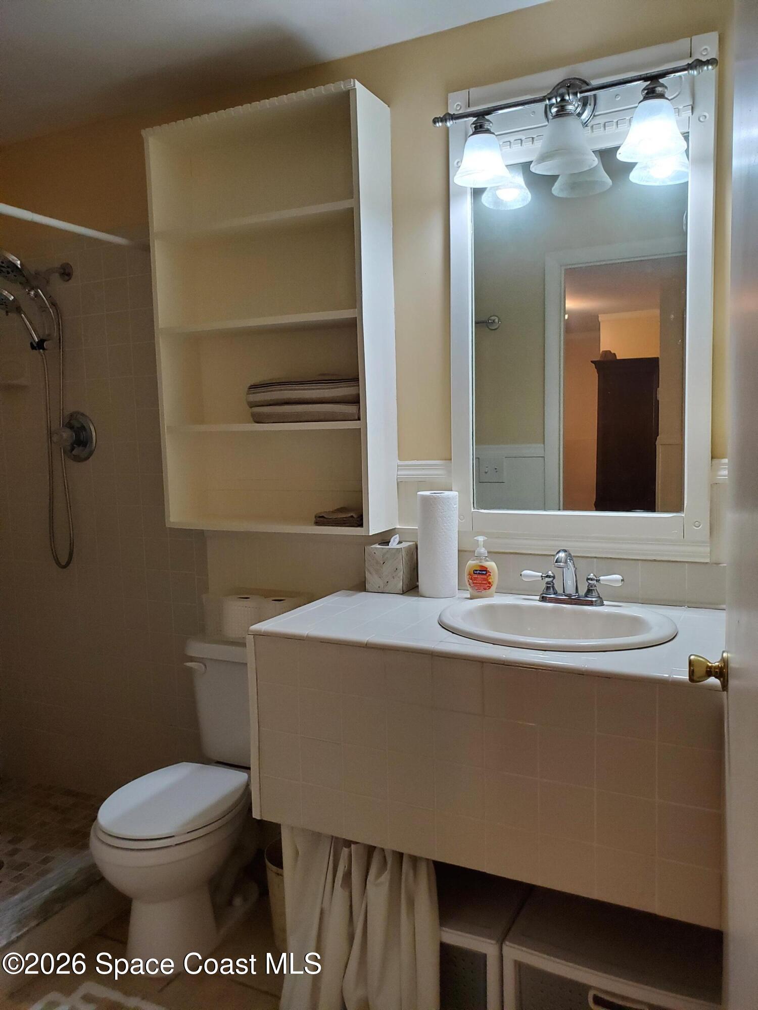 2324 Bignonia Street, Unit 2 Melbourne, FL 32901 - Photo 13 of 19 a bathroom with a sink toilet and mirror