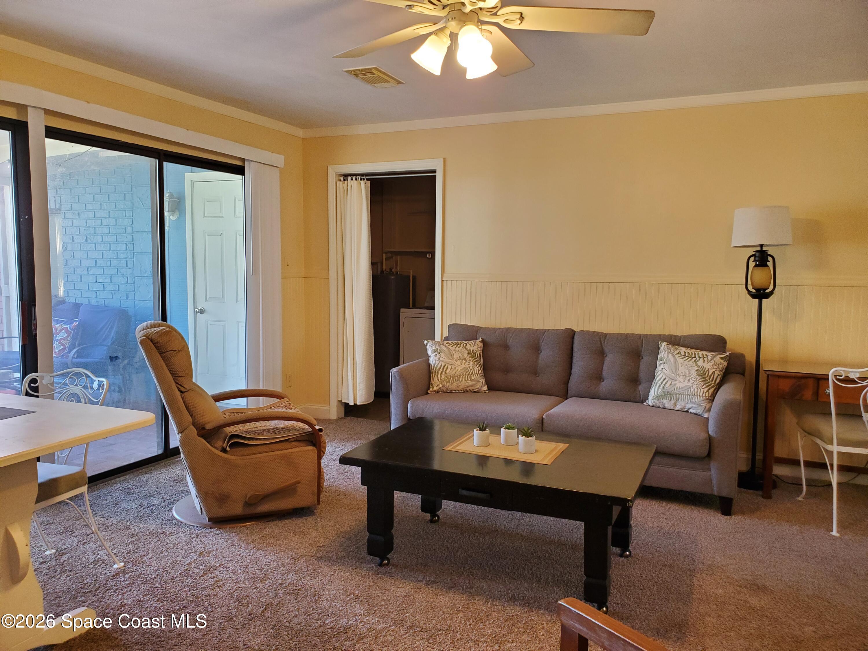 2324 Bignonia Street, Unit 2 Melbourne, FL 32901 - Photo 10 of 19 a living room with furniture a lamp and a potted plant