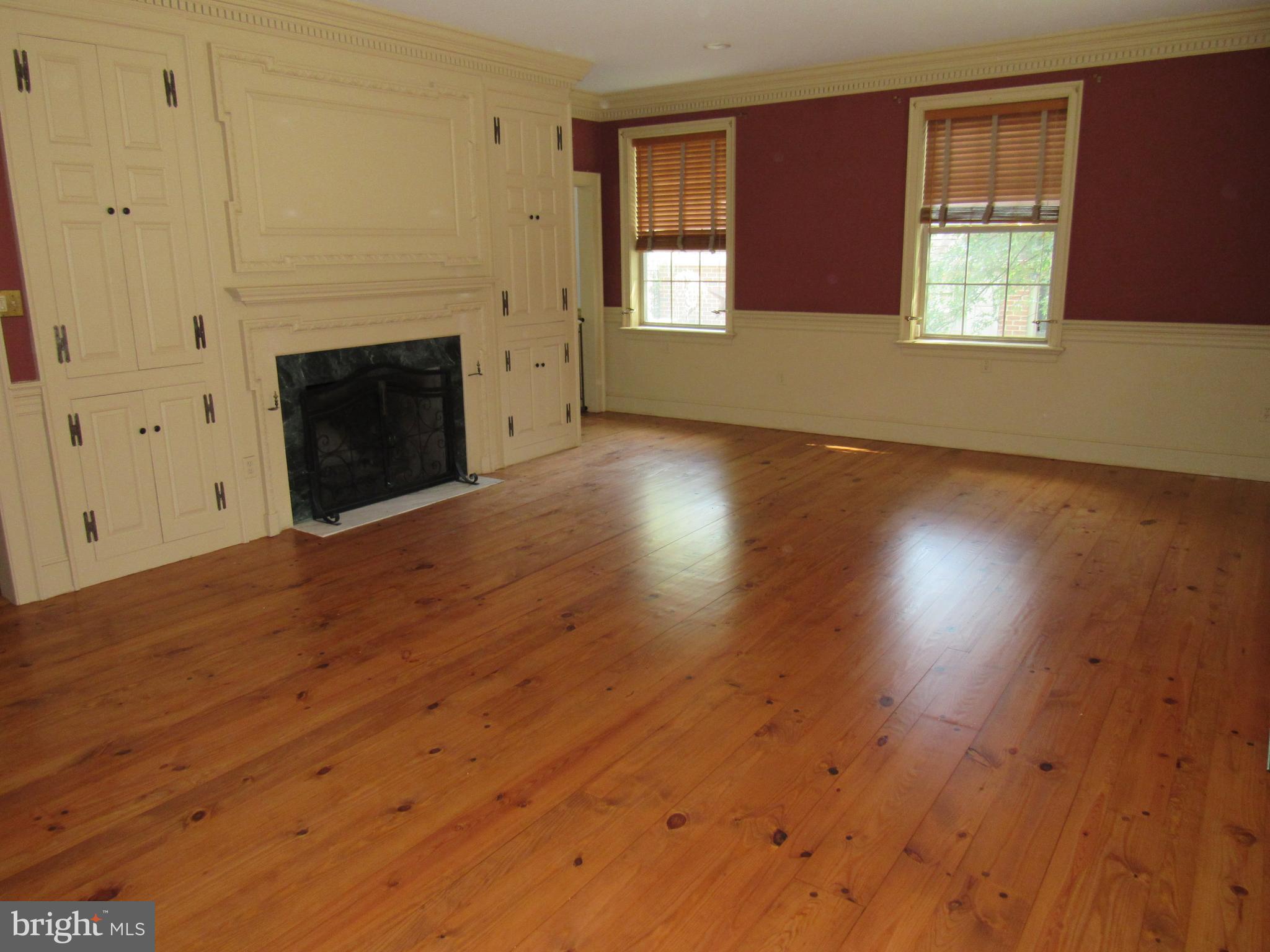 1105 Wilson Street Pottstown, PA 19464 - Photo 29 of 86 an empty room with wooden floor fireplace and windows