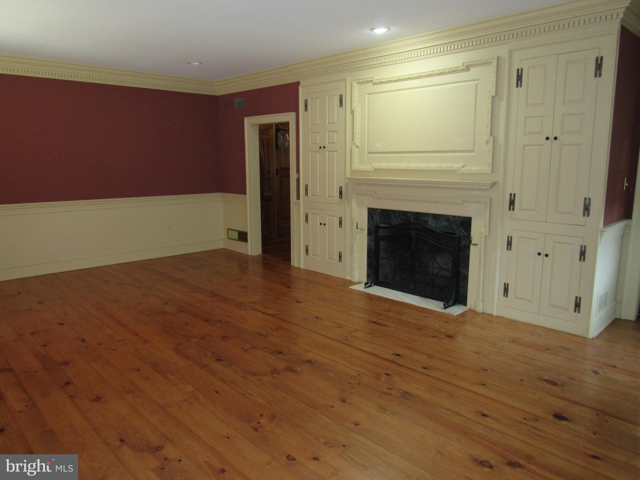 1105 Wilson Street Pottstown, PA 19464 - Photo 31 of 86 a view of empty room with wooden floor and fireplace