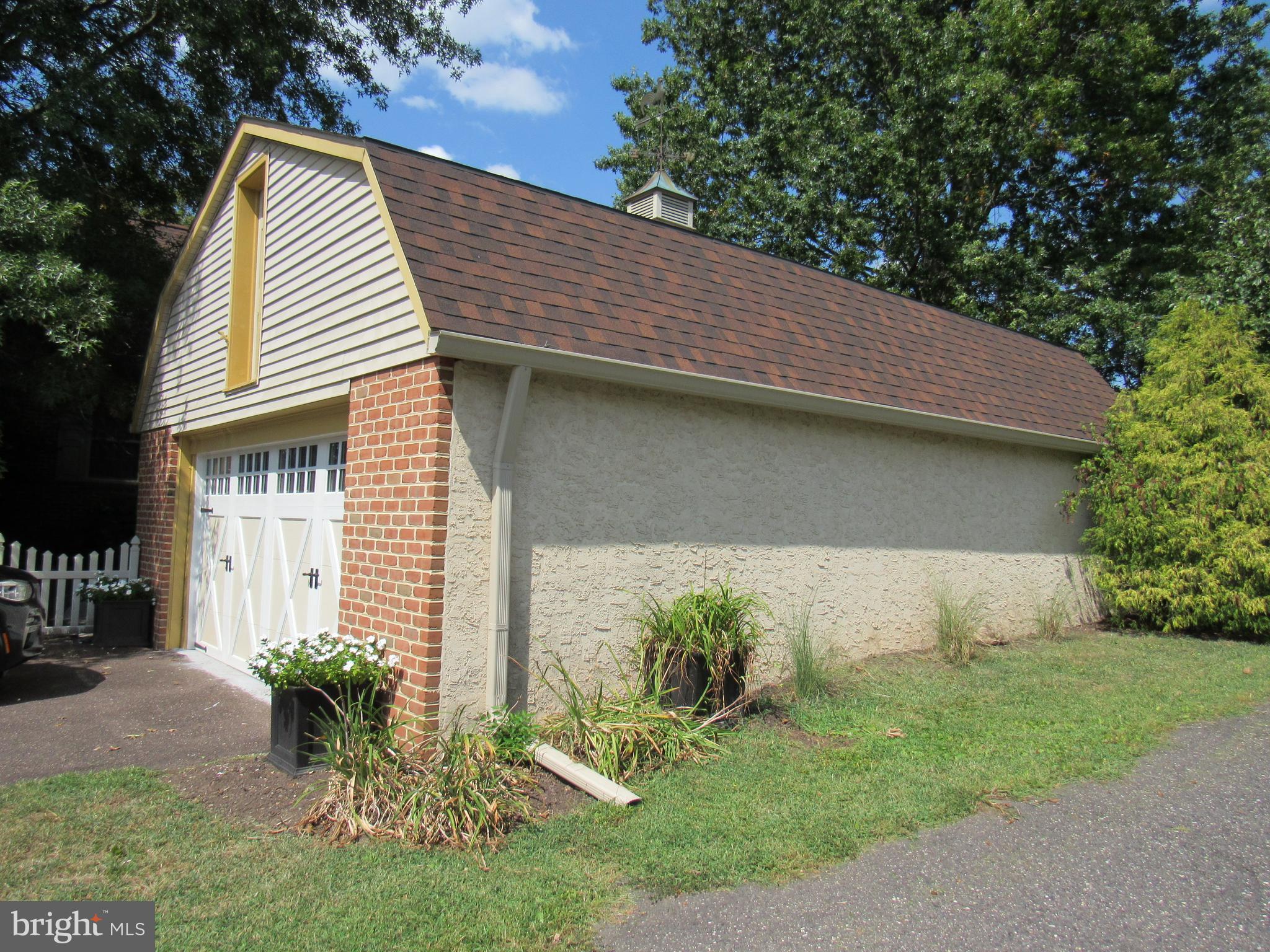 1105 Wilson Street Pottstown, PA 19464 - Photo 55 of 86 a backyard of a house with potted plants and large tree