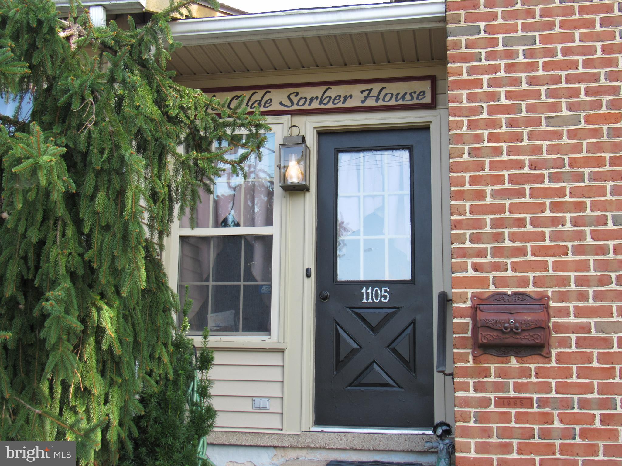 1105 Wilson Street Pottstown, PA 19464 - Photo 7 of 86 a front view of a house with a blue gate