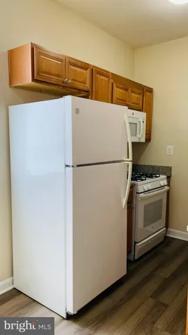 a stove top oven sitting inside of a kitchen
