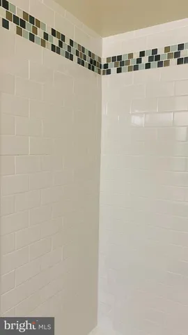 a living room with furniture a flat screen tv and kitchen view