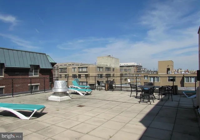a front view of a house with a tree