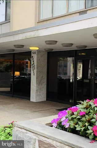 a front view of building with flowers