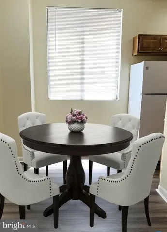 a view of a storage & utility room with a refrigerator