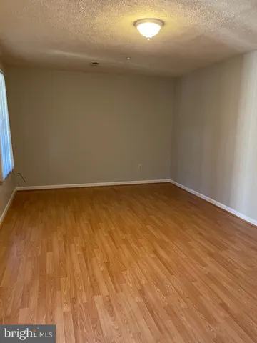 a view of room with wooden floor