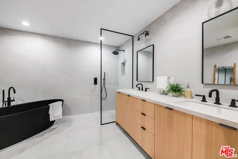 a spacious bathroom with a double vanity sink mirror and double
