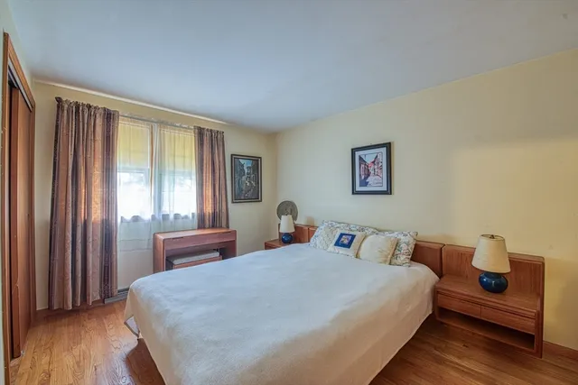 a bedroom with bed and a window