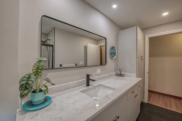 a bathroom with a double vanity sink and a mirror