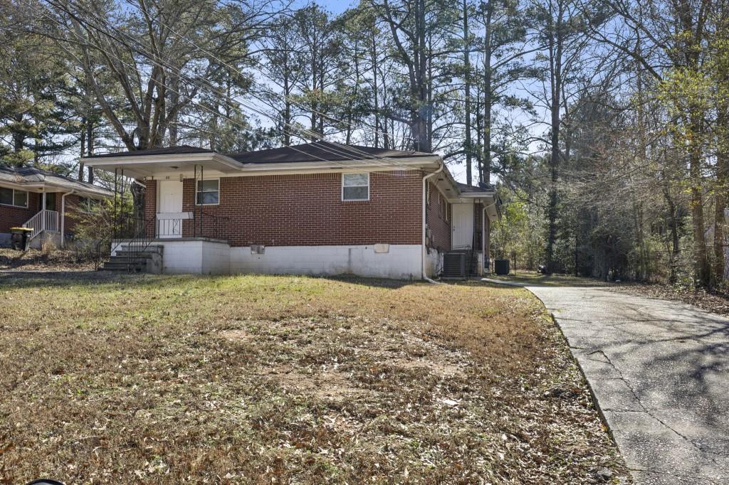 61 Pine Street Northeast Fairburn, GA 30213 - Photo 1 of 22 a front view of a house with a yard and garage