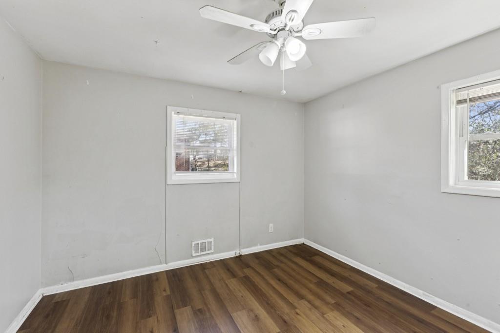 61 Pine Street Northeast Fairburn, GA 30213 - Photo 15 of 22 wooden floor in an empty room with a window