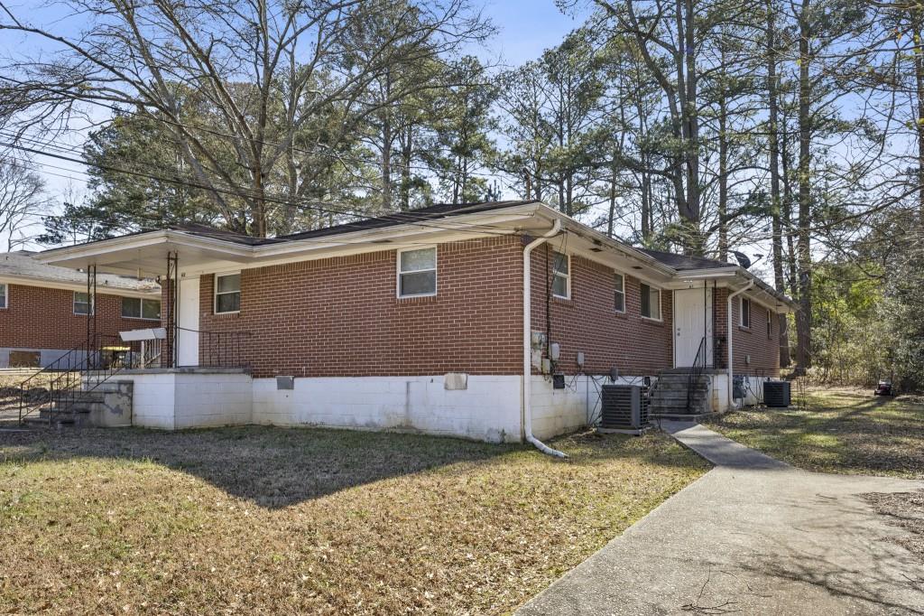 61 Pine Street Northeast Fairburn, GA 30213 - Photo 2 of 22 a view of a house with a yard covered in snow