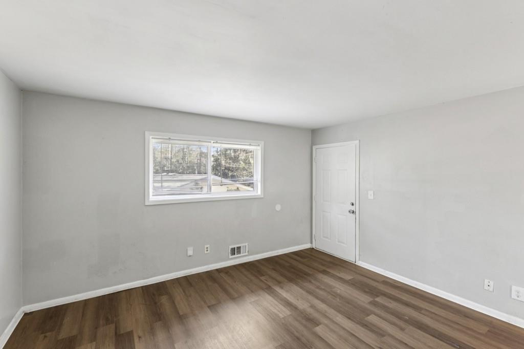61 Pine Street Northeast Fairburn, GA 30213 - Photo 6 of 22 an empty room with wooden floor and windows
