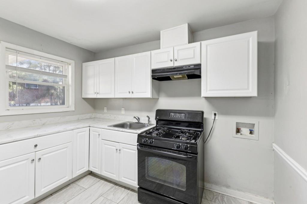 61 Pine Street Northeast Fairburn, GA 30213 - Photo 8 of 22 a kitchen with cabinets appliances and a window